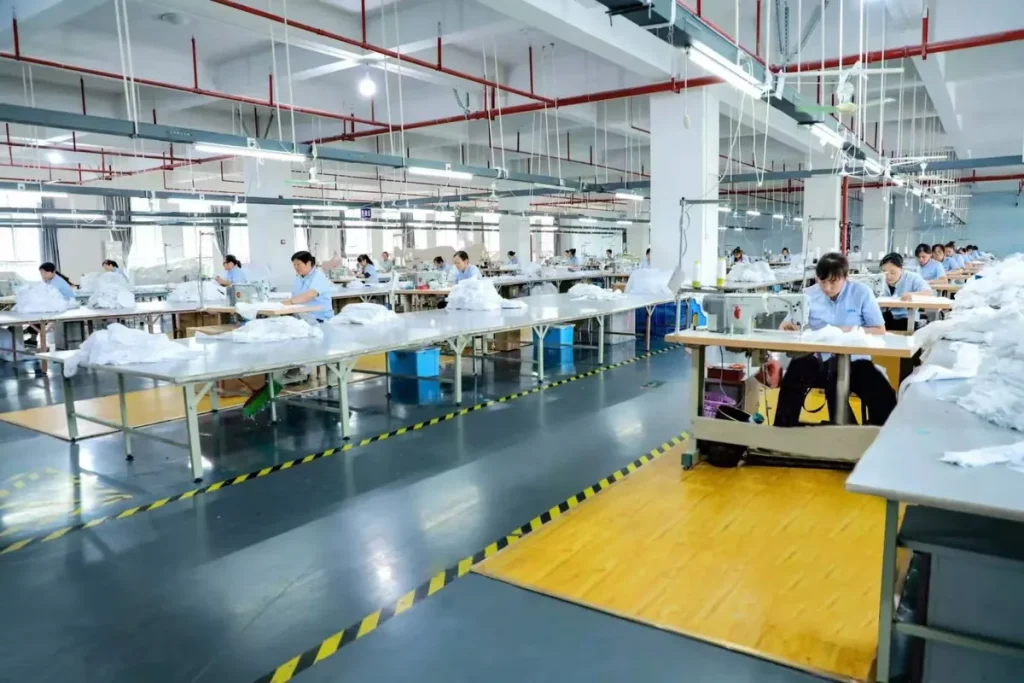 Bedding sewing production floor with rows of industrial sewing machines