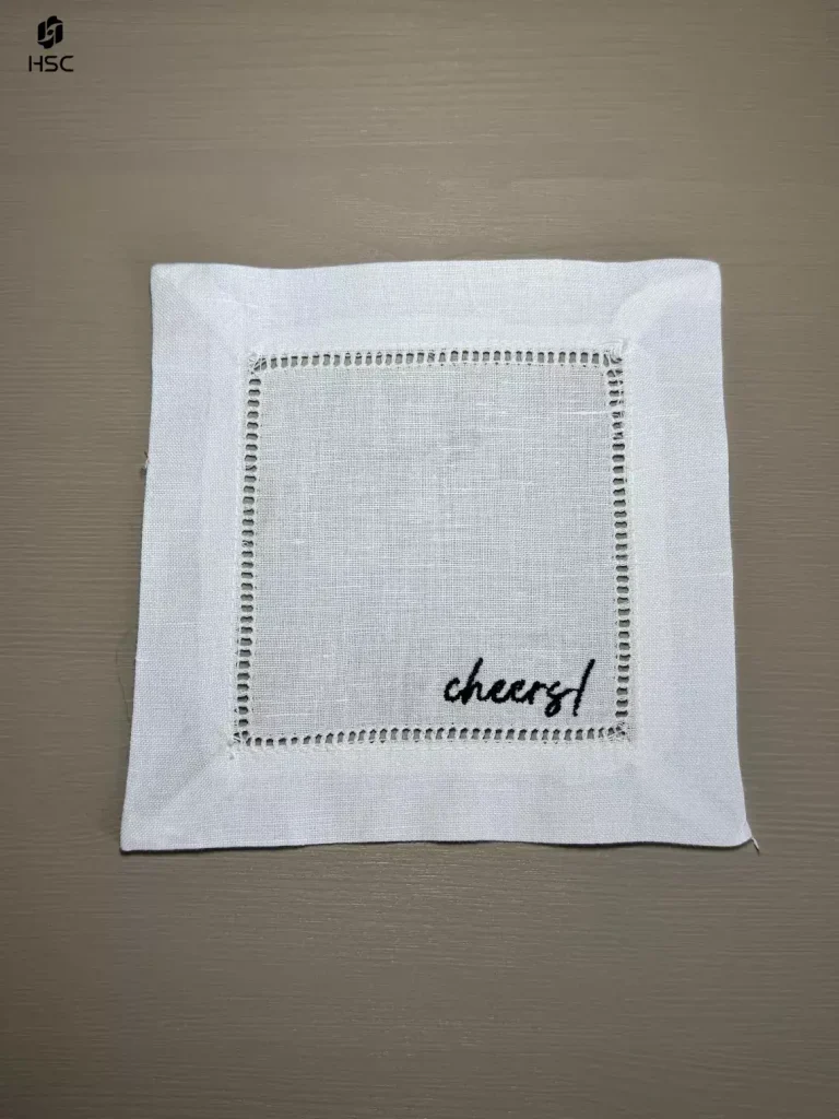 White washed cotton cocktail napkin beside a cream linen dinner napkin