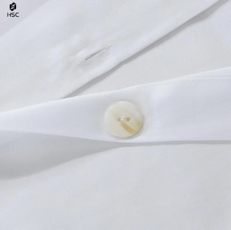 White duvet cover with button and stitching detail close-up