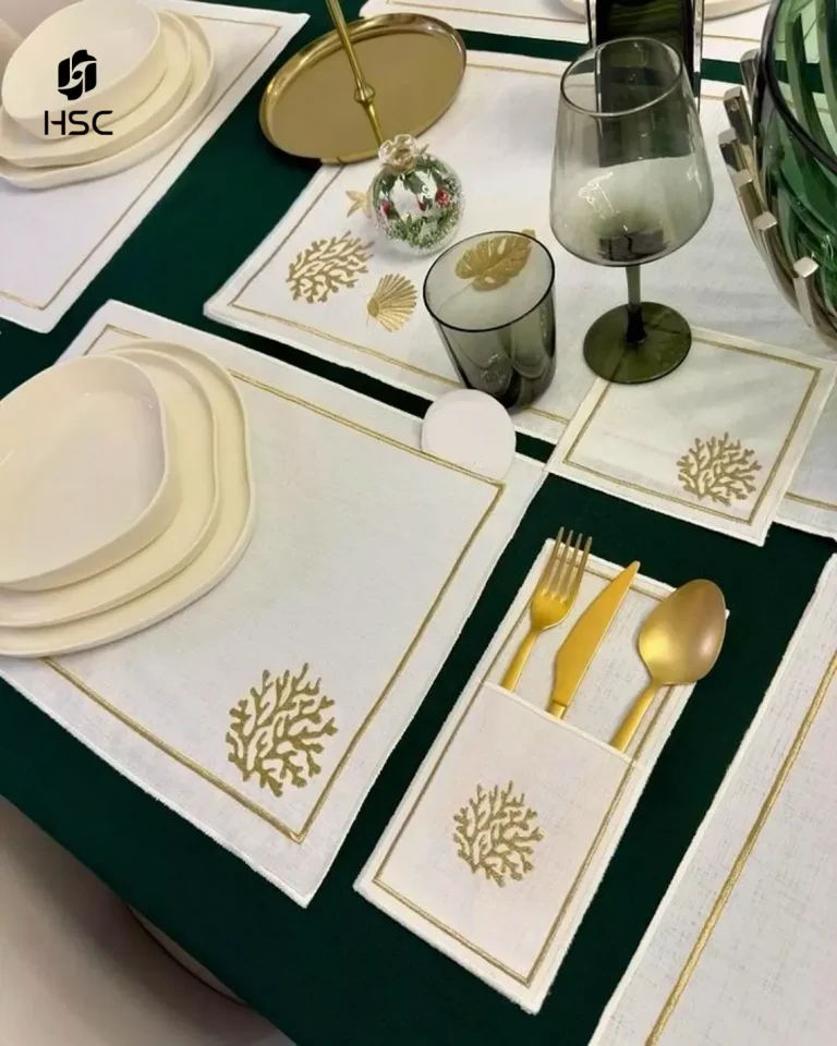 Cream linen dinner napkin with embroidered monogram in sage thread