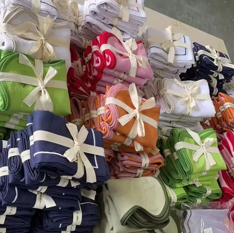 Folded textile bundles tied with ribbons ready for retail packing