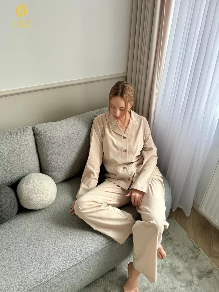 Light cotton pajama set in cream worn on a sofa in daylight