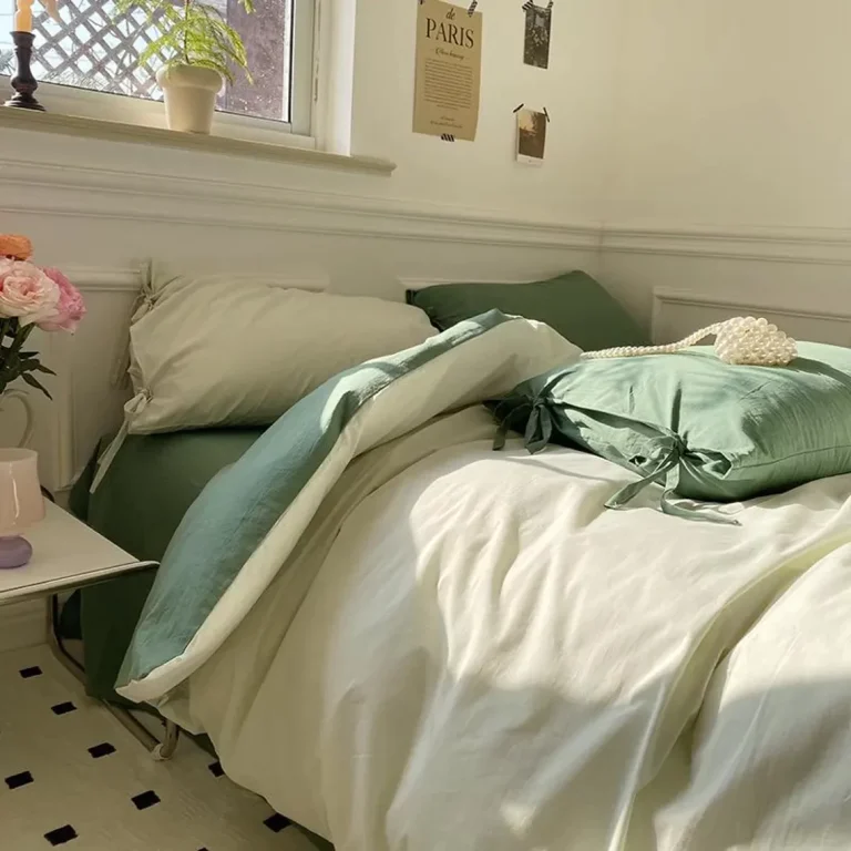 Sage green bedding set with tie closures on a bed